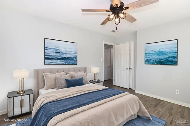 a bedroom with a bed and a painting on the wall