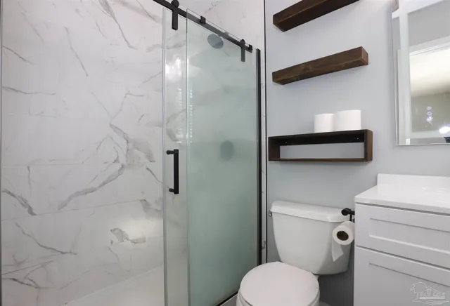 a bathroom with a toilet and a shower