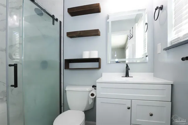 a bathroom with a sink toilet and shower