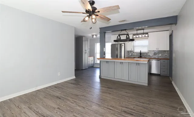 a view of a kitchen with a sink cabinets and wooden floor