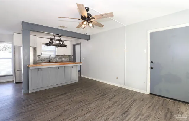 a view of a kitchen with a sink cabinet a kitchen and wooden floor