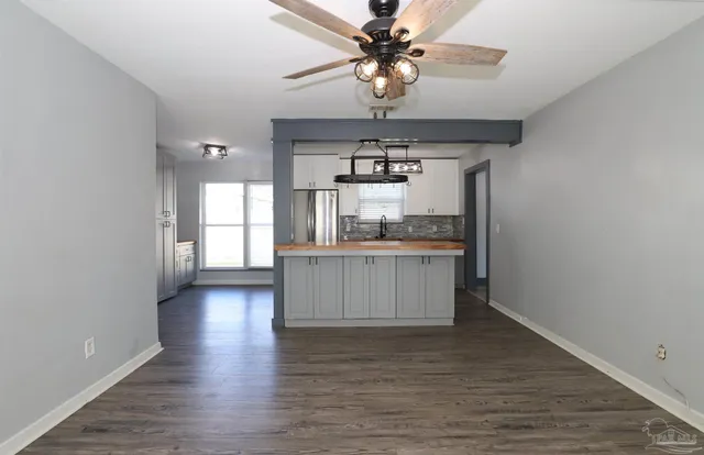 a view of a kitchen with a sink and wooden floor