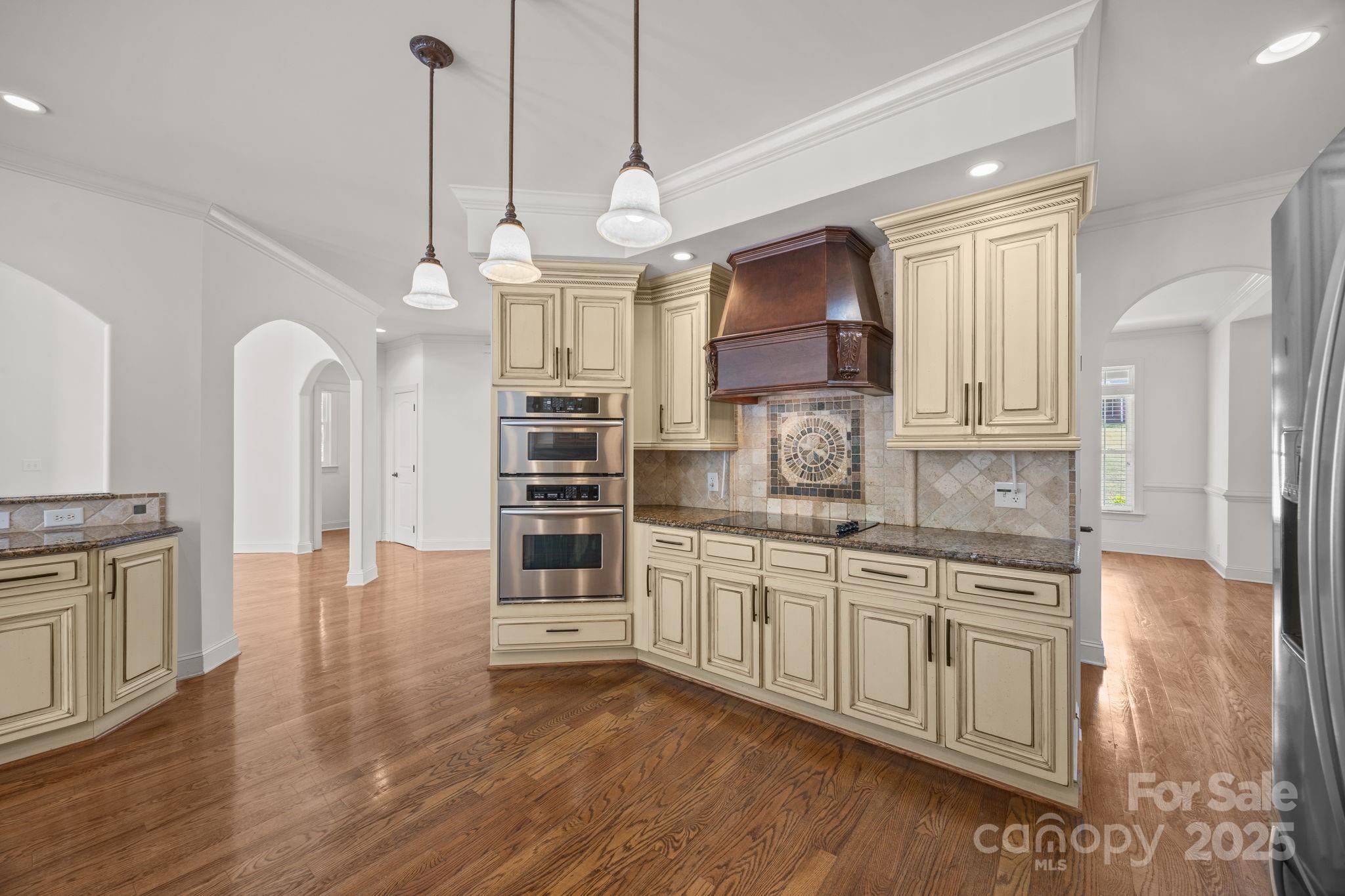110 Devonshire Lane Salisbury, NC 28146 - Photo 18 of 48 a large kitchen with granite countertop a stove a sink a center island and wooden floor