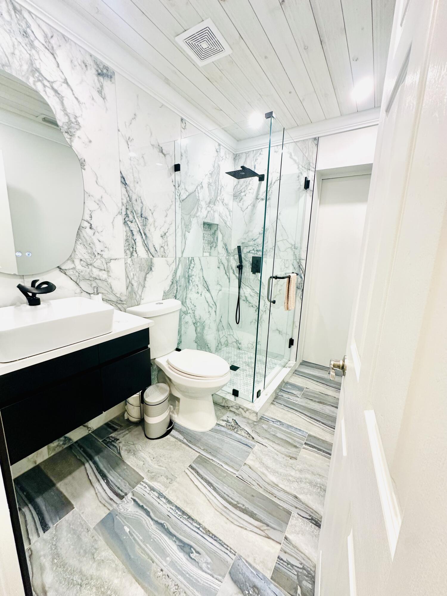 1104 Neoga Street Jupiter, FL 33458 - Photo 13 of 21 a bathroom with a sink toilet and shower