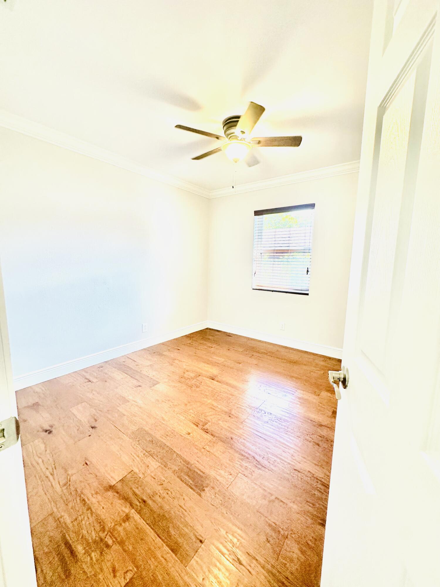 1104 Neoga Street Jupiter, FL 33458 - Photo 14 of 21 an empty room with wooden floor