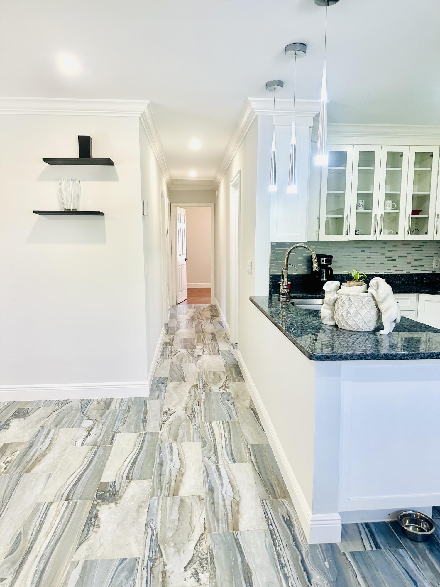 1104 Neoga Street Jupiter, FL 33458 - Photo 7 of 21 a spacious bathroom with a granite countertop sink and a mirror