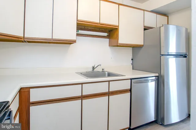 a kitchen with stainless steel appliances a refrigerator and cabinets