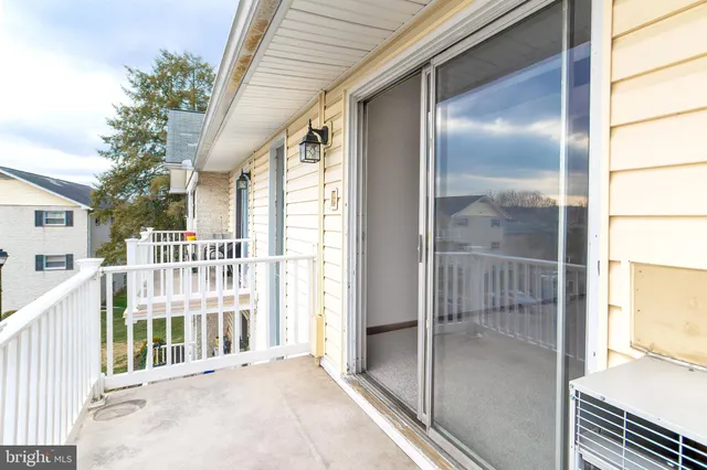 a view of a balcony with wooden floor