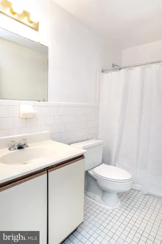 a bathroom with a sink a toilet a mirror and shower