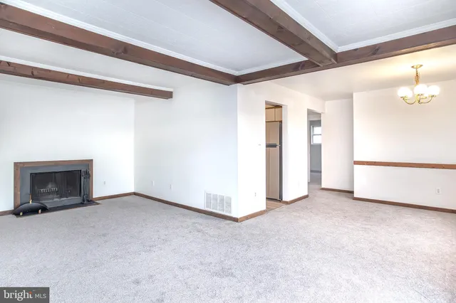 a view of an empty room with a fireplace