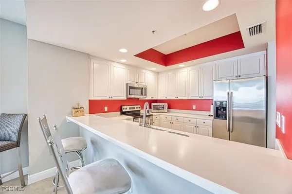 a kitchen with a table chairs stove and refrigerator