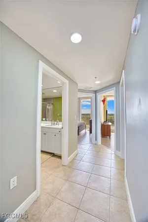 a view of a balcony with wooden floor & fence