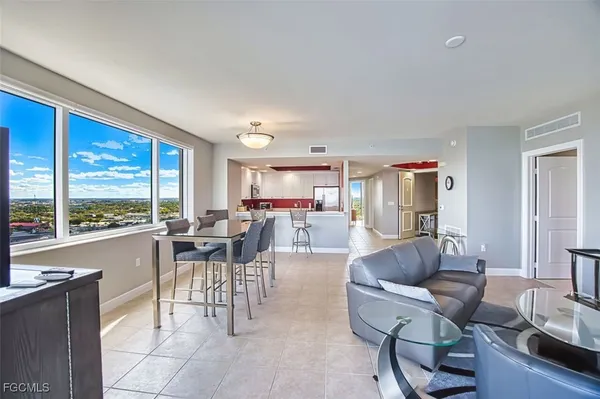 a living room with furniture and large windows