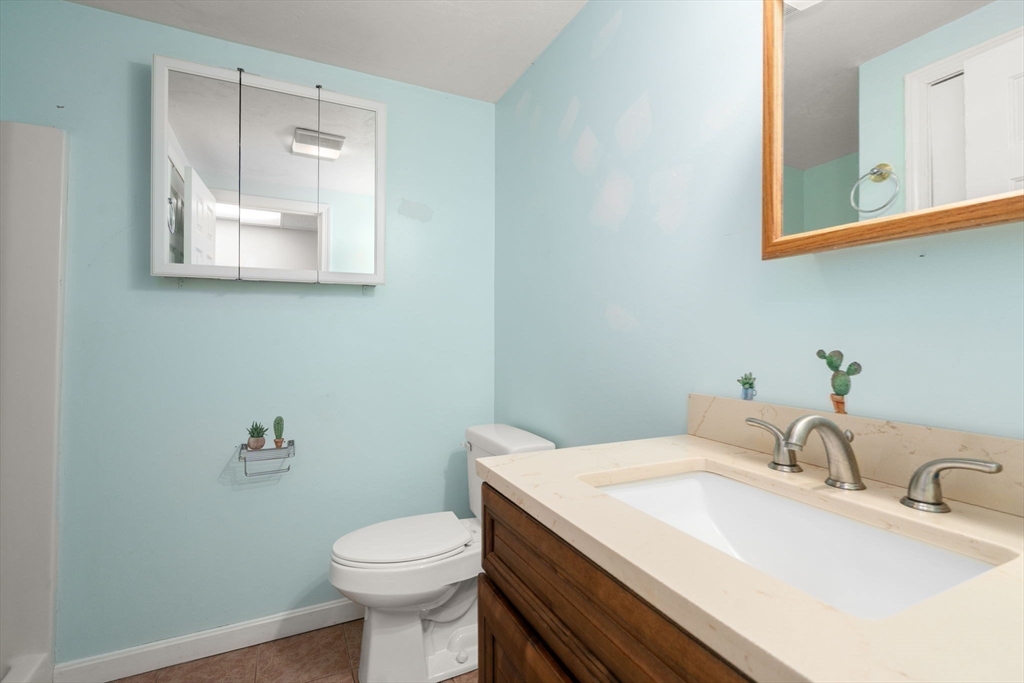53-55 Point Pleasant Road Webster, MA 01570 - Photo 19 of 42 a bathroom with a granite countertop toilet sink and mirror
