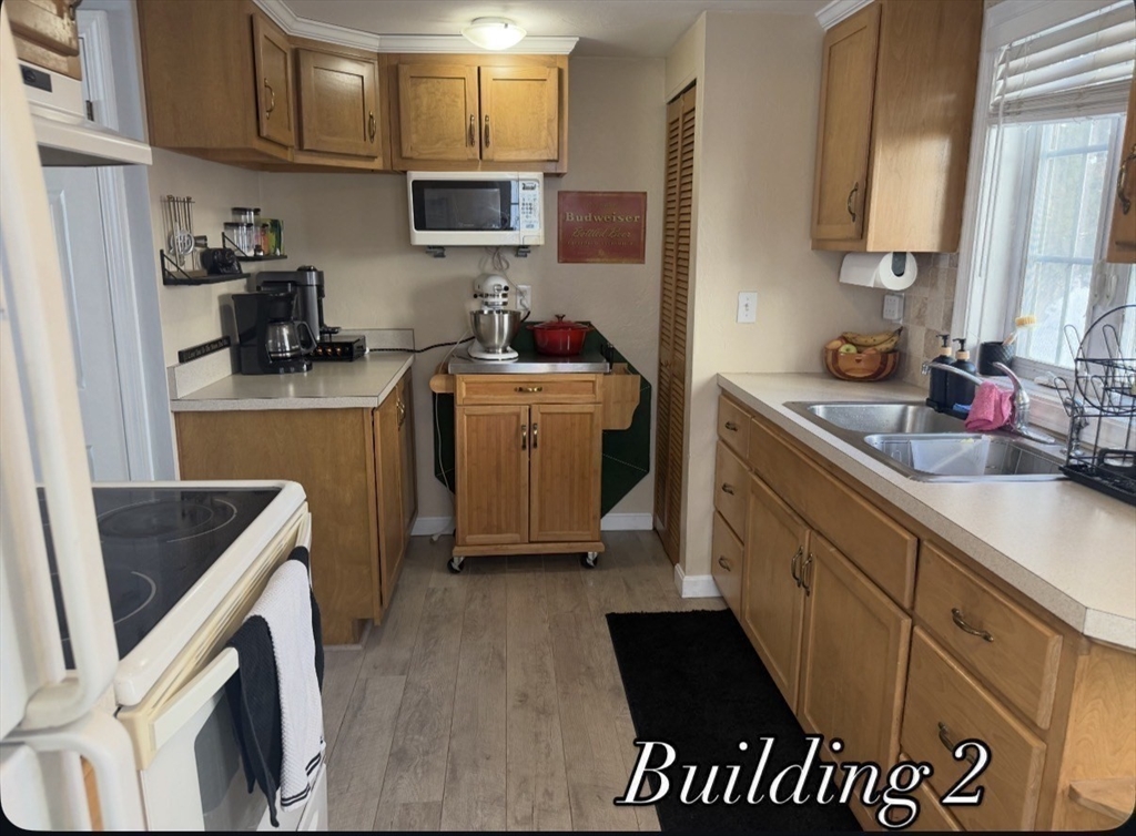 53-55 Point Pleasant Road Webster, MA 01570 - Photo 27 of 42 a kitchen with a sink stove and cabinets