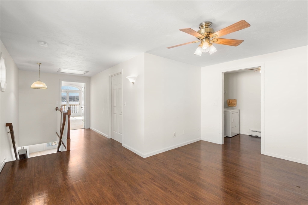 53-55 Point Pleasant Road Webster, MA 01570 - Photo 9 of 42 a view of an empty room with wooden floor and a ceiling fan