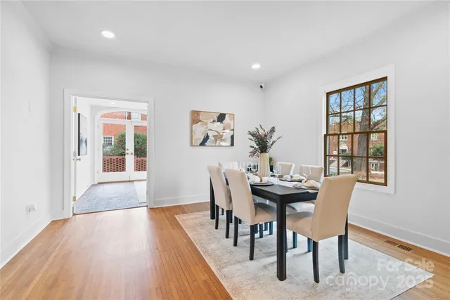 a dining room with furniture and wooden floor