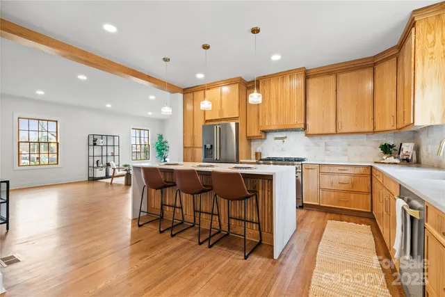 a kitchen with a sink cabinets and wooden floor