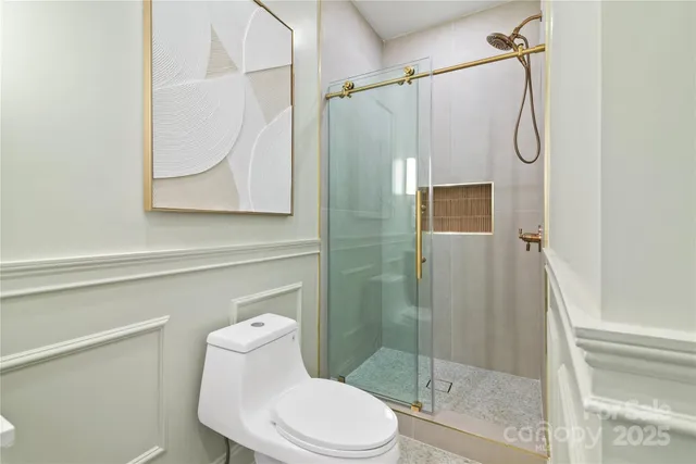 a bathroom with a sink toilet and window