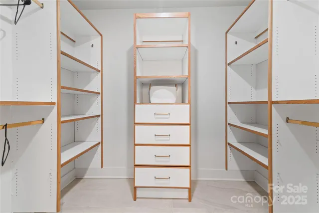 a spacious bedroom with a bed a couch and a window