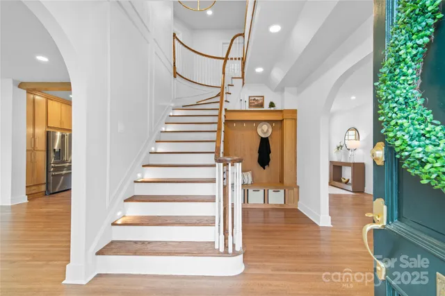 a view of entryway and hall with wooden floor