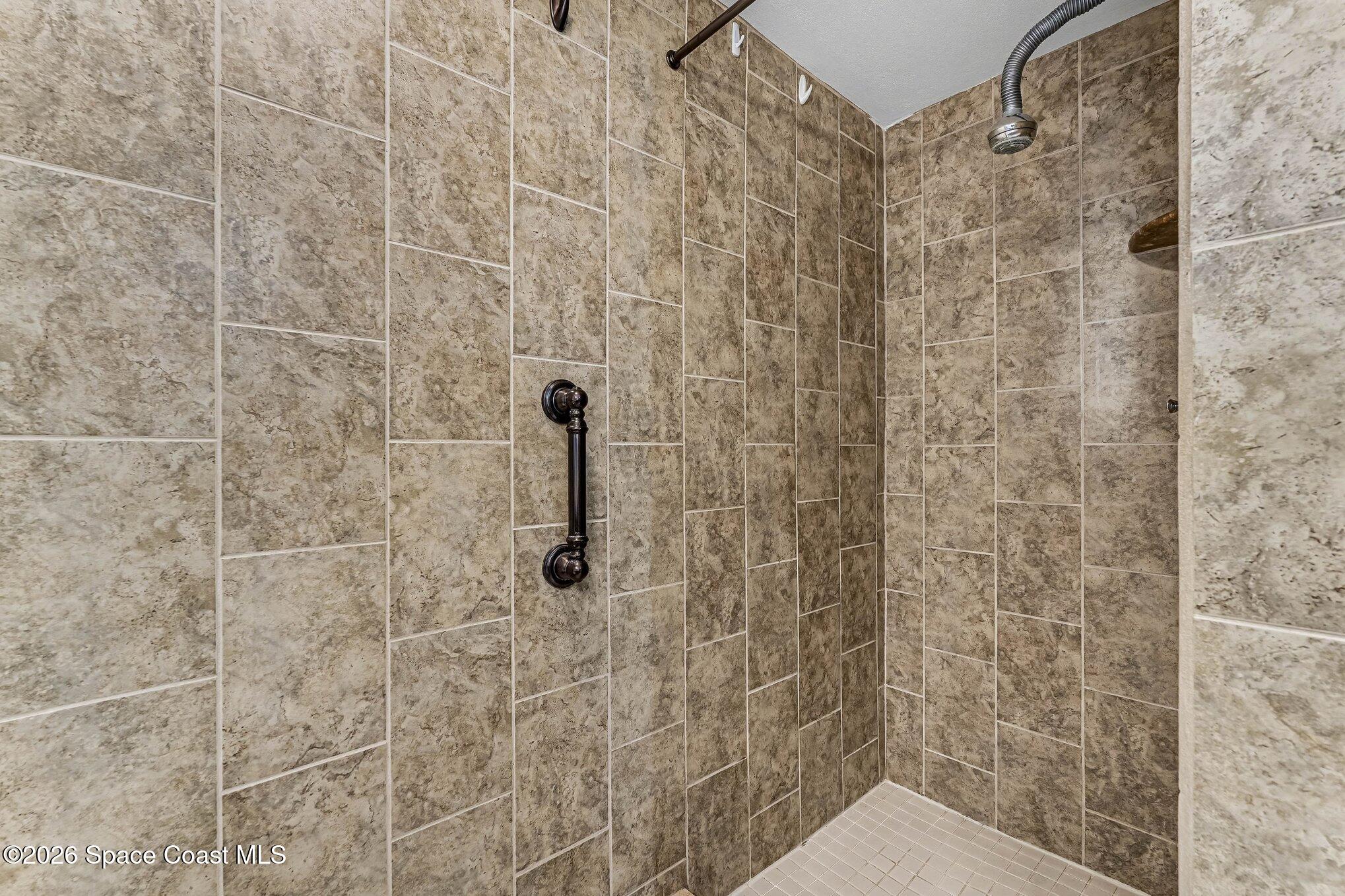 100 Canebreakers Drive, Unit 108 Cocoa, FL 32927 - Photo 12 of 17 a bathroom with a shower