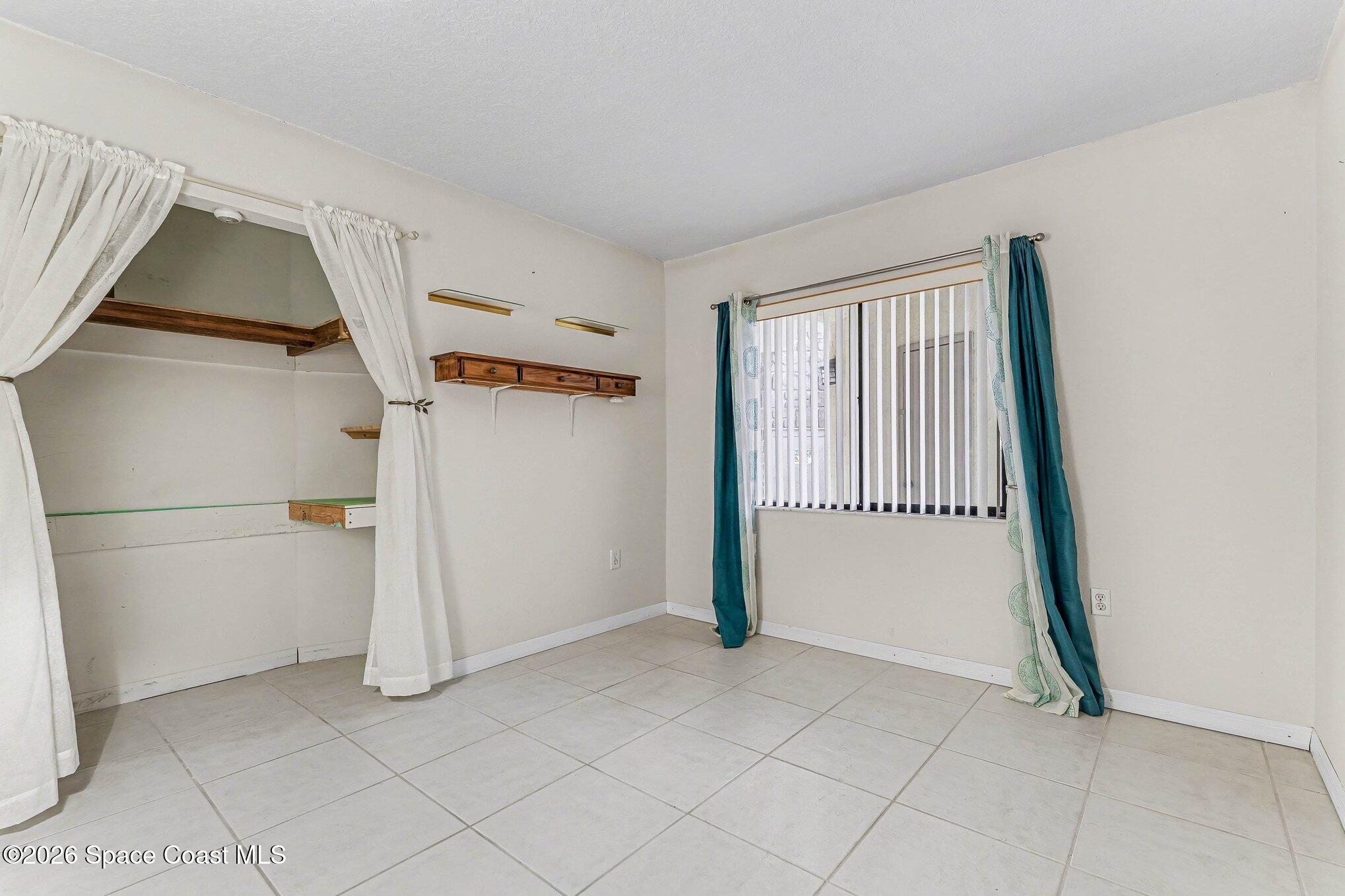 100 Canebreakers Drive, Unit 108 Cocoa, FL 32927 - Photo 13 of 17 a view of a livingroom with an empty space and a hallway
