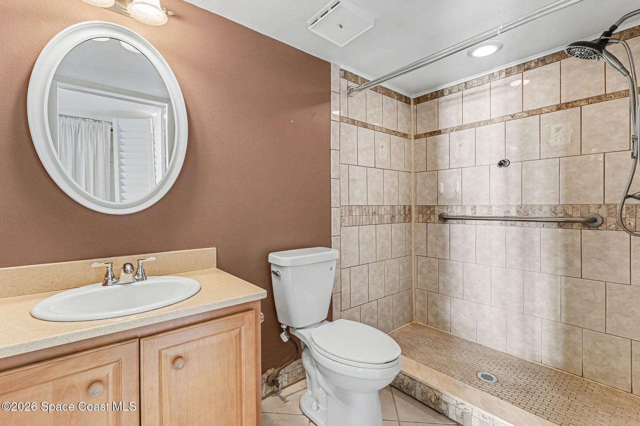 100 Canebreakers Drive, Unit 108 Cocoa, FL 32927 - Photo 14 of 17 a bathroom with a sink a toilet and shower