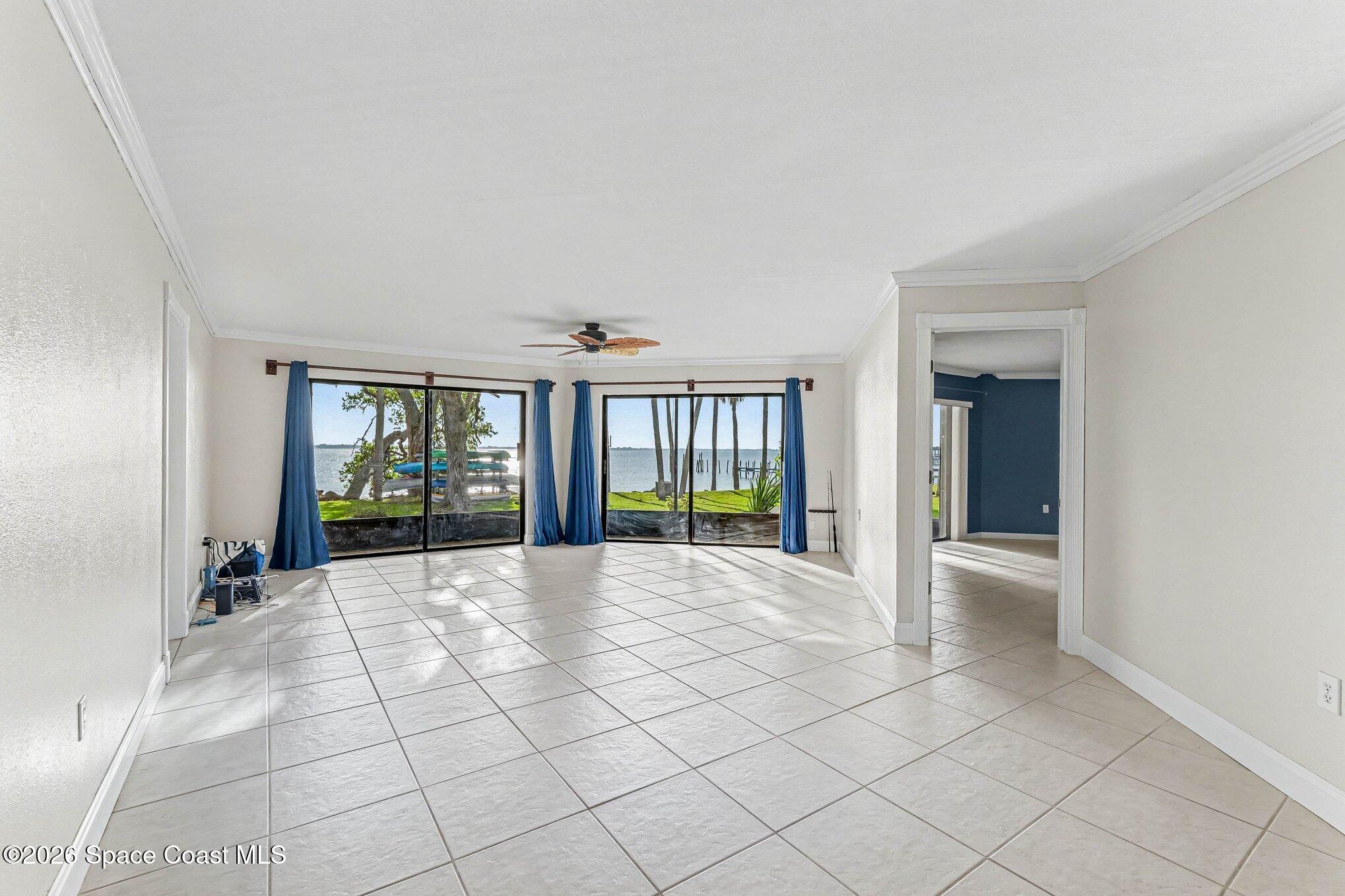 100 Canebreakers Drive, Unit 108 Cocoa, FL 32927 - Photo 4 of 17 a view of an empty room with windows and a kitchen