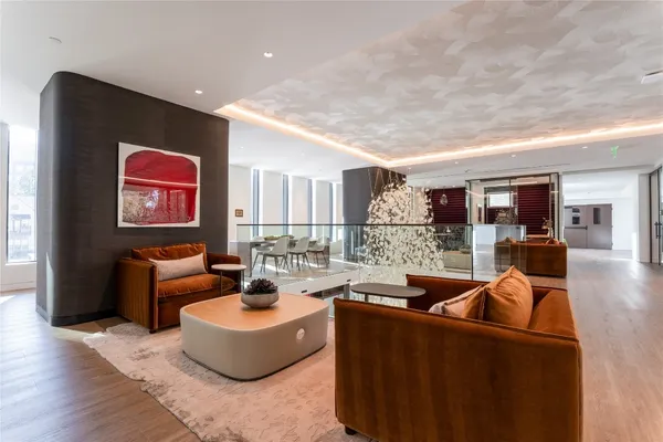 a living room with a couch and large windows