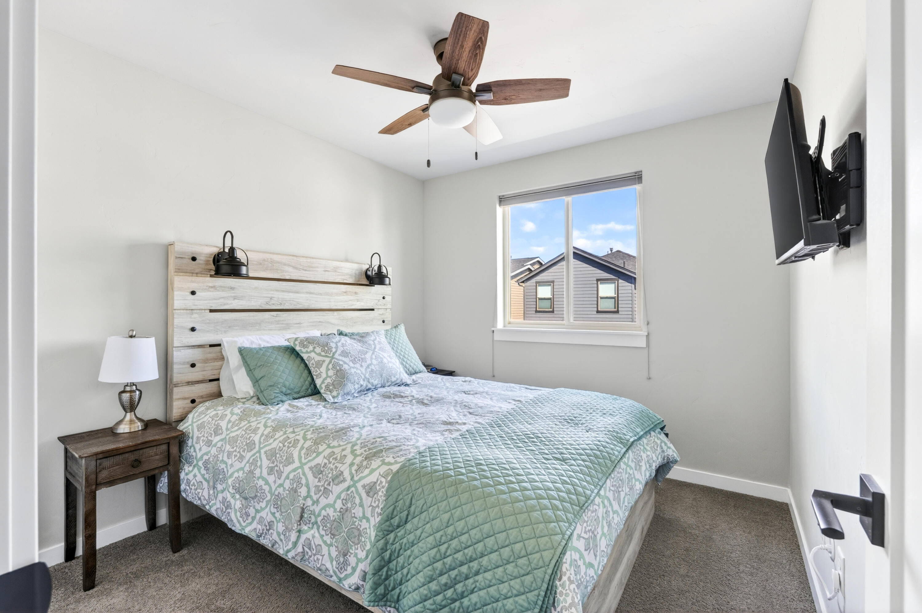 4572 Southwest 37th Street Redmond, OR 97756 - Photo 12 of 19 a bedroom with a bed and a flat tv screen on a dresser