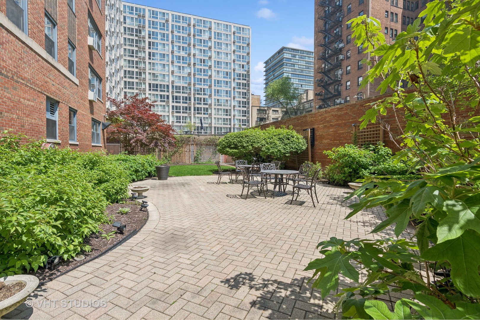 2909 North Sheridan Road, Unit 609 Chicago, IL 60657 - Photo 11 of 11 a view of a patio with a table and chairs and potted plants