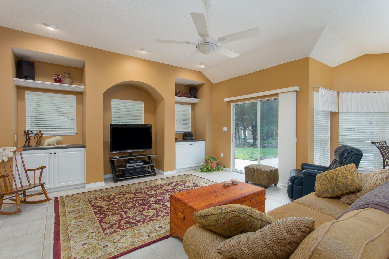 2573 Cove Road Navarre, FL 32566 - Photo 8 of 28 a living room with furniture a flat screen tv and a large window