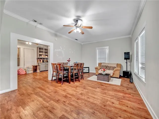 a living room with furniture and a dining table