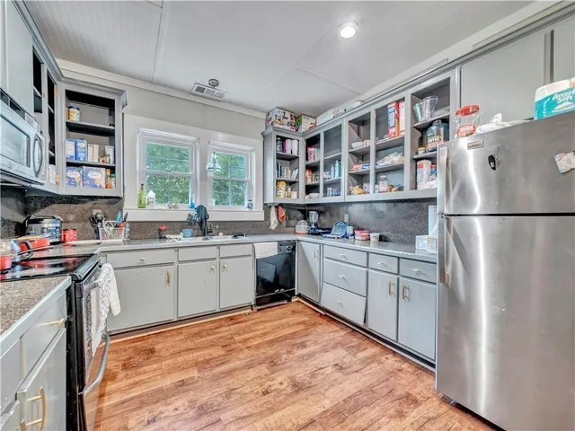a kitchen with a refrigerator and a sink