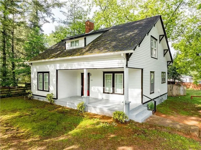 a front view of a house with a yard table and chairs