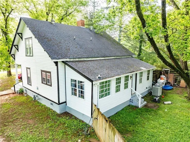 a aerial view of a house with a yard table and chairs