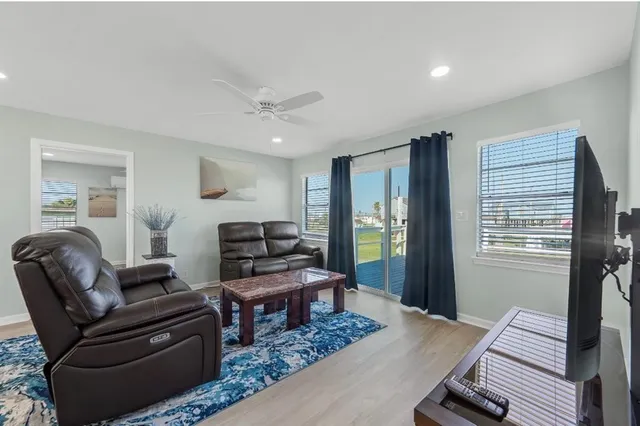 a living room with furniture and wooden floor