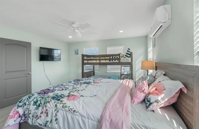 a bedroom with a bed and a flat screen tv