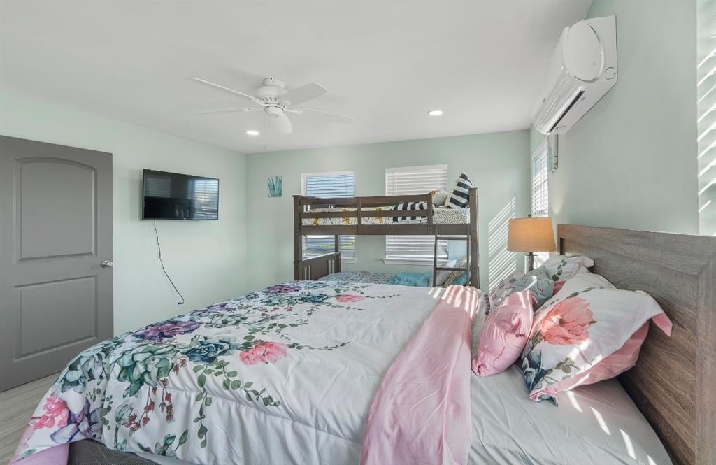 1019 Treaty Drive Surfside Beach, TX 77541 - Photo 15 of 43 a bedroom with a bed and a flat screen tv
