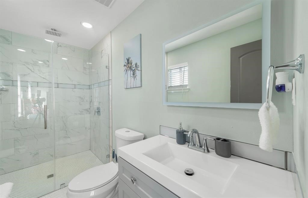 1019 Treaty Drive Surfside Beach, TX 77541 - Photo 16 of 43 a bathroom with a sink a toilet and shower