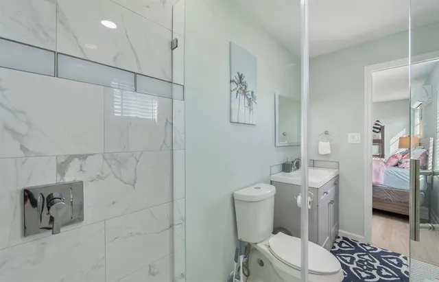 a bathroom with a toilet a sink and shower