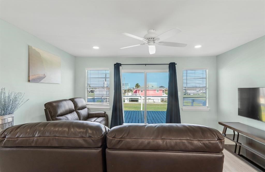 1019 Treaty Drive Surfside Beach, TX 77541 - Photo 19 of 43 a living room with a couch and a flat screen tv