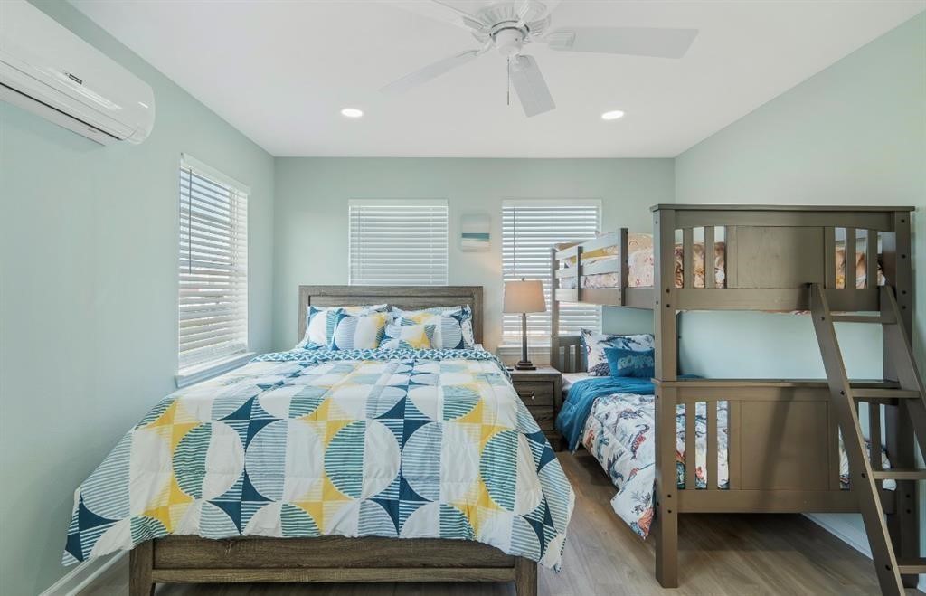 1019 Treaty Drive Surfside Beach, TX 77541 - Photo 22 of 43 a bedroom with bed and wooden floor