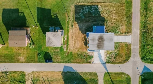 an aerial view of a garden with houses