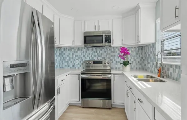 a kitchen with granite countertop a stainless steel appliances and cabinets