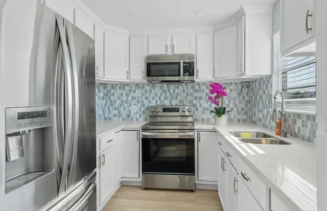 a kitchen with granite countertop a stainless steel appliances and cabinets