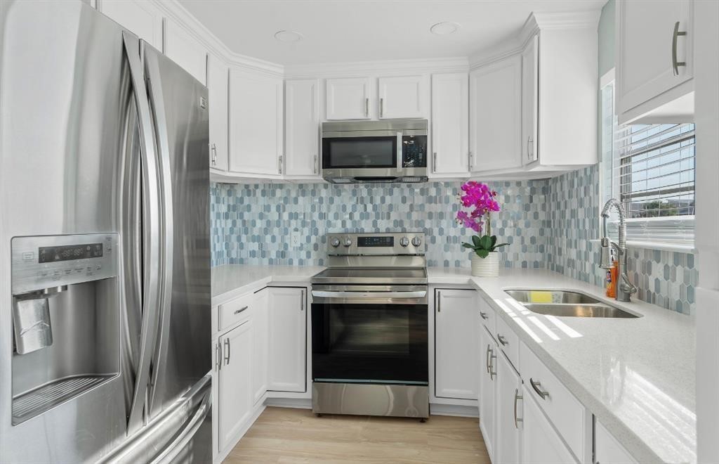 1019 Treaty Drive Surfside Beach, TX 77541 - Photo 8 of 43 a kitchen with granite countertop a stainless steel appliances and cabinets