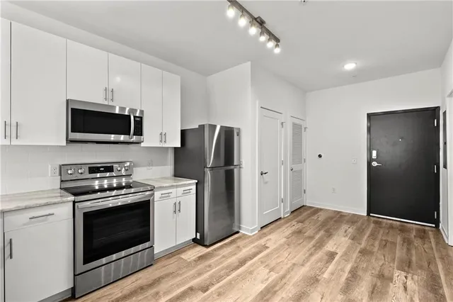 a kitchen with a stove and a refrigerator