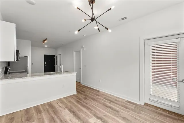 a view of a living room with a ceiling fan and a rug